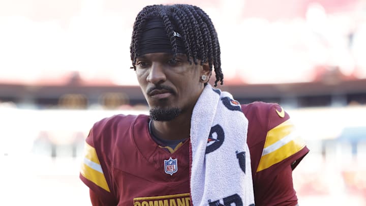 Oct 20, 2024; Landover, Maryland, USA; Washington Commanders quarterback Jayden Daniels (5) walks off the field during the first quarter after an injury against the Carolina Panthers at Northwest Stadium. Mandatory Credit: Amber Searls-Imagn Images