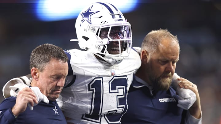 Dec 9, 2024; Arlington, Texas, USA; Dallas Cowboys linebacker DeMarvion Overshown (13) is helped off the field after an injury in the second half against the Cincinnati Bengals at AT&T Stadium. Mandatory Credit: Tim Heitman-Imagn Images