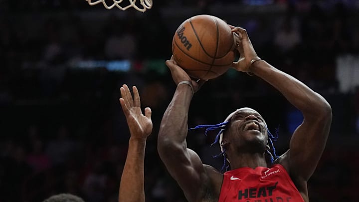 Dec 7, 2024; Miami, Florida, USA;  Miami Heat forward Jimmy Butler (22) shoots the ball against Phoenix Suns guard Devin Booker (1) during the second half at Kaseya Center. Mandatory Credit: Jim Rassol-Imagn Images