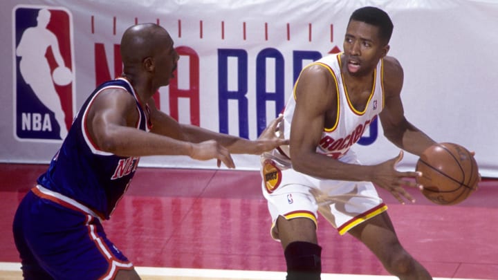 Jun 1994; Houston, TX, USA: FILE PHOTO; Houston Rockets guard Kenny Smith (30) is defended by New