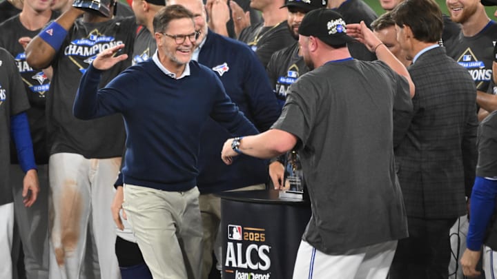 Toronto Blue Jays general manager Ross Atkins celebrates with manager John Schneider (14) after winning game seven of the ALCS. 