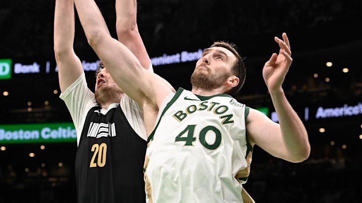Feb 4, 2024; Boston, Massachusetts, USA; Boston Celtics center Luke Kornet (40) shoots the ball against Memphis Grizzlies forward Matt Hurt (20) during the first half at TD Garden. Mandatory Credit: Eric Canha-Imagn Images