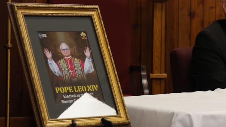 A photo of newly announced Pope Leo XIV sits next to Bishop Robert Coerver of the Catholic Diocese of Lubbock as he speaks at a news conference on May 8, 2025, in Lubbock, Texas, about American-born Cardinal Robert Prevost being chosen as the leader of the Roman Catholic Church.