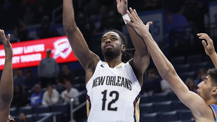 Nov 13, 2024; Oklahoma City, Oklahoma, USA; New Orleans Pelicans guard Antonio Reeves (12) shoots between Oklahoma City Thunder forward Adam Flagler (14) and forward Malevy Leons (17) during the second half at Paycom Center. Mandatory Credit: Alonzo Adams-Imagn Images