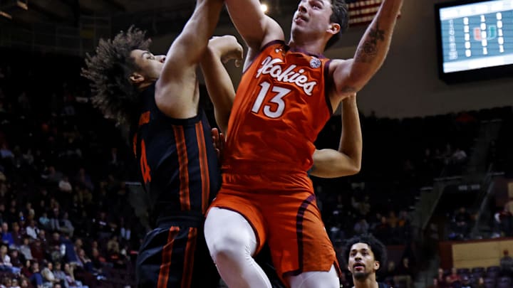 Jan 4, 2025; Blacksburg, Virginia, USA; Virginia Tech Hokies forward Ben Burnham (13) shoots the ball against Miami Hurricanes forward Isaiah Johnson-Arigu (4) during the first half at Cassell Coliseum. Mandatory Credit: Peter Casey-Imagn Images Jan 4, 2025; Blacksburg, Virginia, USA; Virginia Tech Hokies forward Ben Burnham (13) shoots the ball against Miami Hurricanes forward Isaiah Johnson-Arigu (4) during the first half at Cassell Coliseum. Mandatory Credit: Peter Casey-Imagn Images