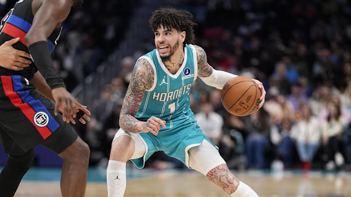 Feb 9, 2026; Charlotte, North Carolina, USA; Charlotte Hornets guard LaMelo Ball (1) handles the ball against Detroit Pistons guard/forward Ausar Thompson (9) during the second quarter at Spectrum Center. Mandatory Credit: Jim Dedmon-Imagn Images