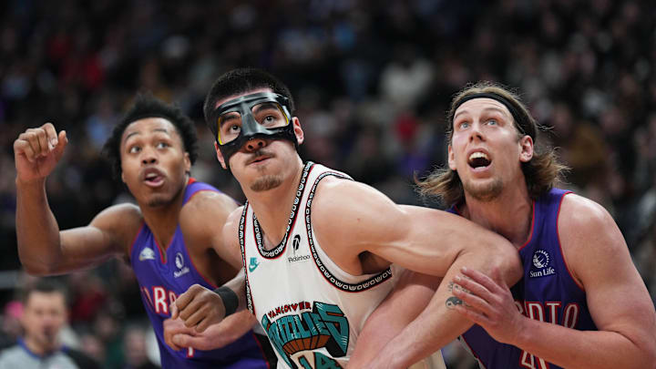 Feb 5, 2025; Toronto, Ontario, CAN; Memphis Grizzlies center Zach Edey (14) battles with Toronto Raptors forward Kelly Olynyk (41) during the third quarter at Scotiabank Arena. Mandatory Credit: Nick Turchiaro-Imagn Images