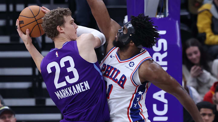Dec 28, 2024; Salt Lake City, Utah, USA; Utah Jazz forward Lauri Markkanen (23) goes to the basket against Philadelphia 76ers center Joel Embiid (21) during the second quarter at Delta Center. Mandatory Credit: Rob Gray-Imagn Images