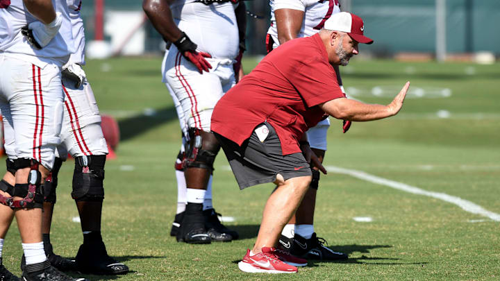 The Crimson Tide players and coaches continue working toward the season opener in practice Tuesday, Aug. 13, 2024. Alabama offensive line coach Chris Kapilovic directs his linemen.