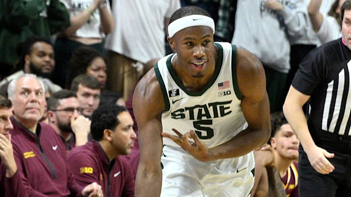 Jan 28, 2025; East Lansing, Michigan, USA;  Michigan State Spartans guard Tre Holloman (5) celebrates a three point basket against the Minnesota Golden Gophers during the first half at Jack Breslin Student Events Center. Mandatory Credit: Dale Young-Imagn Images