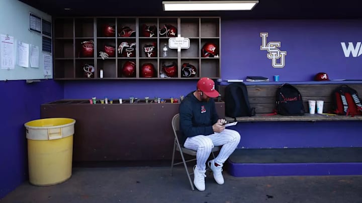 Alabama coach Rob Vaughn in the dugout at Alex Box Stadium.
