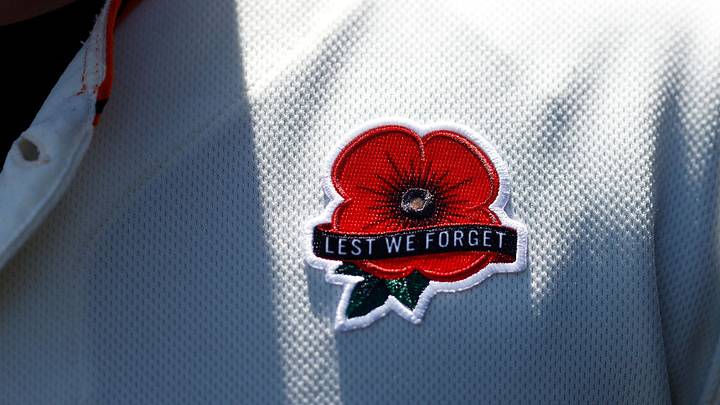 Poppy patch reading "lest we forget"