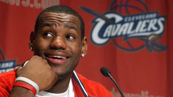 LeBron James answers questions from a throng of media members gathered 