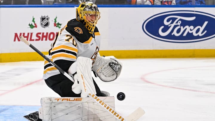 Nov 27, 2024; Elmont, New York, USA;  Boston Bruins goaltender Joonas Korpisalo (70) makes a save against the New York Islanders during the second period at UBS Arena. Mandatory Credit: Dennis Schneidler-Imagn Images