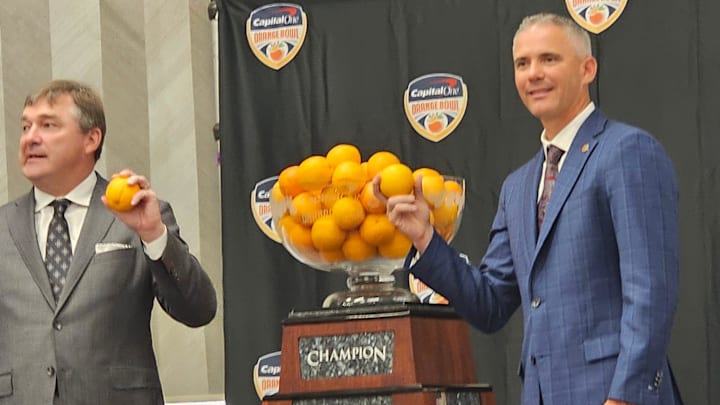 FSU head coach Mike Norvell and Georgia head coach Kirby Smart pose with oranges. FSU head coach Mike Norvell and Georgia head coach Kirby Smart pose with oranges.