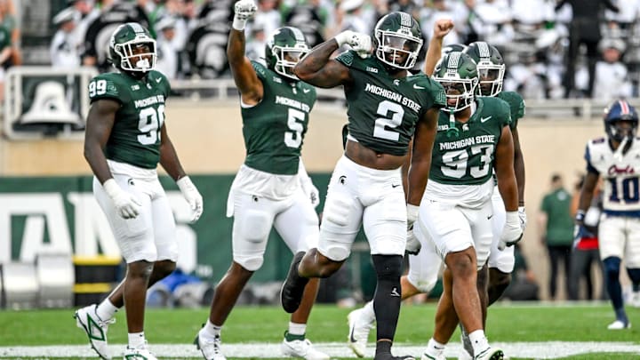 Michigan State's Khris Bogle, center, celebrates his stop against Florida Atlantic during the first quarter on Friday, Aug. 30, 2024, at Spartan Stadium in East Lansing.