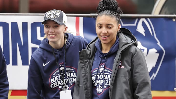 UConn’s Paige Bueckers and Azzi Fudd walk onto the stage during the Final Four Champions victory parade.