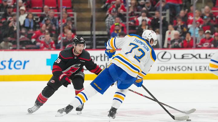Jan 19, 2026; Raleigh, North Carolina, USA;  aCarolina Hurricanes defenseman Sean Walker (26) watches Buffalo Sabres center Tage Thompson (72) skate with the puck during the third period t Lenovo Center. Mandatory Credit: James Guillory-Imagn Images