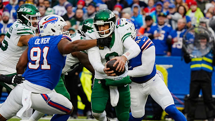 New York Jets quarterback Aaron Rodgers (8) gets sacked by Buffalo Bills defensive tackle Ed Oliver (91) and Buffalo Bills linebacker Von Miller (40) during second half action at the Bills home game against the New York Jets at Highmark Stadium in Orchard Park on Dec. 29, 2024.