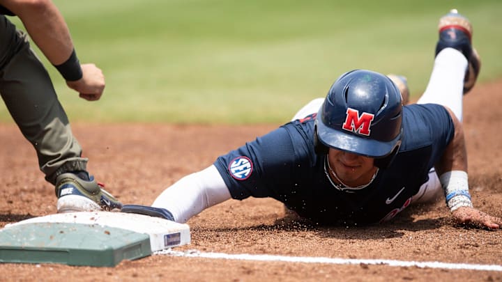 Ole Miss Rebels' Hayden Federico (9) slides safely back into first base as Ole Miss Rebels take on Vanderbilt Commodores during the SEC baseball tournament championship game at Hoover Met in Birmingham, Ala., on Sunday, May 25, 2025.