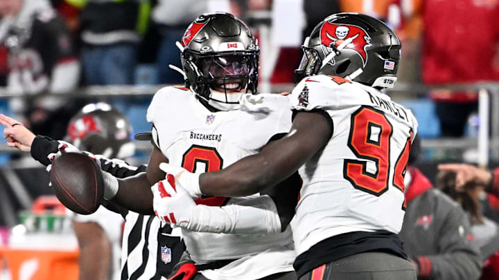 Dec 1, 2024; Charlotte, North Carolina, USA; Tampa Bay Buccaneers linebacker Yaya Diaby (0) celebrates with defensive tackle Calijah Kancey (94) after recovering a fumble in overtime in overtime at Bank of America Stadium. Mandatory Credit: Bob Donnan-Imagn Images