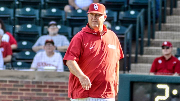 Oklahoma coach Skip Johnson walks to the dugout.