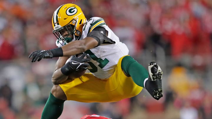 Green Bay Packers running back Emanuel Wilson hurdles San Francisco 49ers linebacker Dre Greenlaw in the fourth quarter during their NFC divisional playoff football game Saturday, January 20, 2024, at Levi's Stadium in Santa Clara, California.