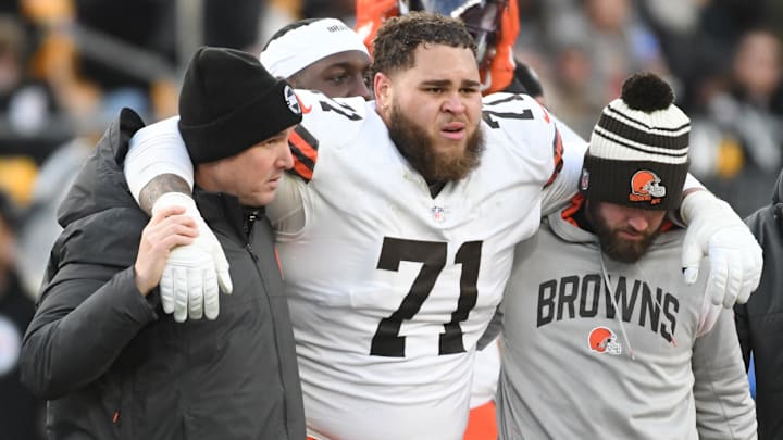 Jan 8, 2023; Pittsburgh, Pennsylvania, USA; Injured Cleveland Browns tackle Jedrick Wills Jr. (71) is helped off the field in a game against the Pittsburgh Steelers during the fourth quarter at Acrisure Stadium. Jan 8, 2023; Pittsburgh, Pennsylvania, USA; Injured Cleveland Browns tackle Jedrick Wills Jr. (71) is helped off the field in a game against the Pittsburgh Steelers during the fourth quarter at Acrisure Stadium.