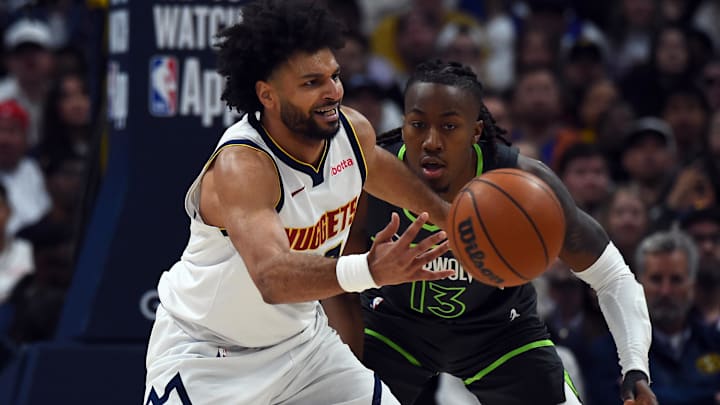 Apr 18, 2026; Denver, Colorado, USA; Denver Nuggets guard Jamal Murray (27) handles the ball as he is defended by Minnesota Timberwolves guard Ayo Dosunmu (13) during the first half in game one of the first round of the 2026 NBA Playoffs at Ball Arena. Mandatory Credit: Christopher Hanewinckel-Imagn Images