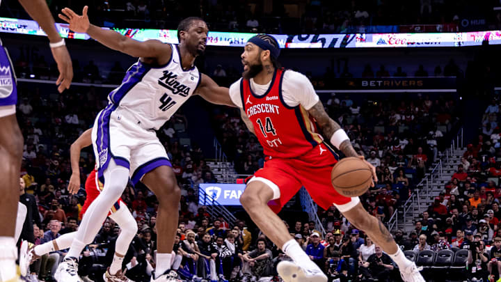 Apr 19, 2024; New Orleans, Louisiana, USA;  New Orleans Pelicans forward Brandon Ingram (14) dribbles against Sacramento Kings forward Harrison Barnes (40) in the first half during a play-in game of the 2024 NBA playoffs at Smoothie King Center. 