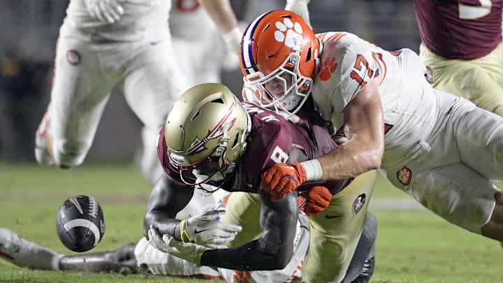 Oct 5, 2024; Tallahassee, Florida, USA; Clemson Tigers linebacker Wade Woodaz (17) forces a fumble by Florida State Seminoles wide receiver Hykeem Williams (8) during the second half at Doak S. Campbell Stadium. 
