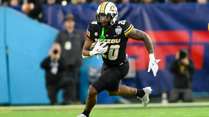 Dec 30, 2024; Nashville, TN, USA;  Missouri Tigers running back Jamal Roberts (20) runs the ball against the Iowa Hawkeyes during the second half at Nissan Stadium. Mandatory Credit: Steve Roberts-Imagn Images