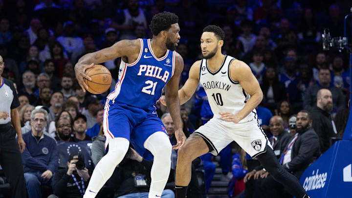 Jan 25, 2023; Philadelphia, Pennsylvania, USA; Philadelphia 76ers center Joel Embiid (21) controls the ball against Brooklyn Nets guard Ben Simmons (10) during the first quarter at Wells Fargo Center. Mandatory Credit: Bill Streicher-Imagn Images