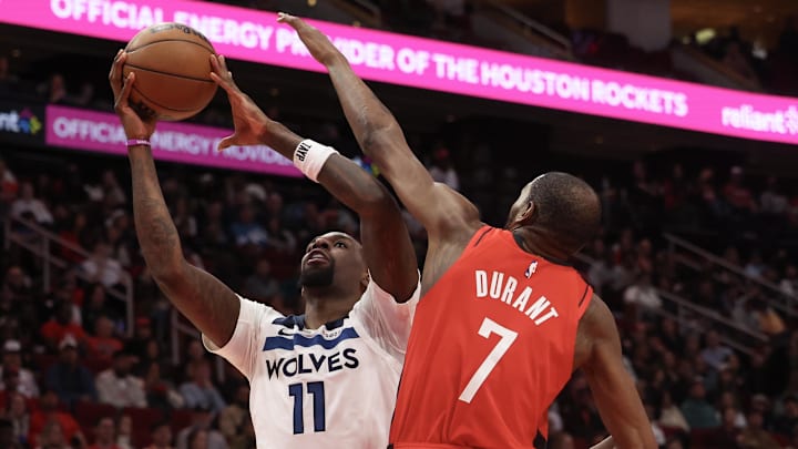 Jan 16, 2026; Houston, Texas, USA; Minnesota Timberwolves center Naz Reid (11) drives to the net against Houston Rockets forward Kevin Durant (7) in the second quarter at Toyota Center. Mandatory Credit: Thomas Shea-Imagn Images