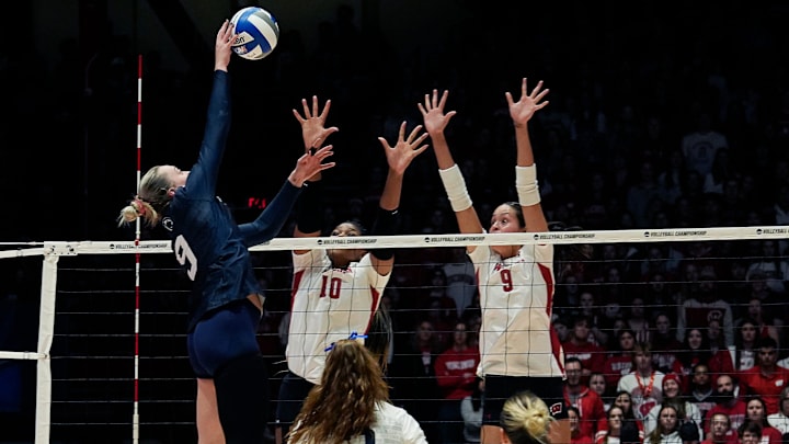 Wisconsin opposite Devyn Robinson (10) and middle blocker Caroline Crawford (9) attempt to block the shot from Penn State outside hitter Jess Mruzik (9)