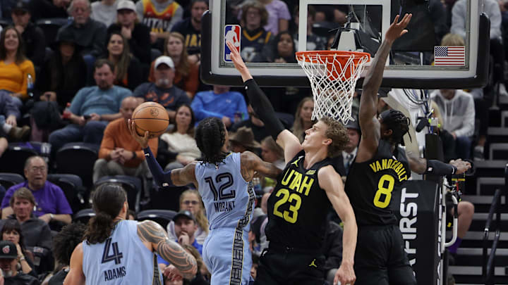 Memphis Grizzlies guard Ja Morant (12) tries to shoot the ball past Utah Jazz forward Lauri Markkanen (23) during the second quarter at Vivint Arena. Mandatory Credit: Chris Nicoll-Imagn Images Memphis Grizzlies guard Ja Morant (12) tries to shoot the ball past Utah Jazz forward Lauri Markkanen (23) during the second quarter at Vivint Arena. Mandatory Credit: Chris Nicoll-Imagn Images