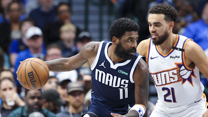 Nov 8, 2024; Dallas, Texas, USA; Dallas Mavericks guard Kyrie Irving (11) controls the ball as Phoenix Suns guard Tyus Jones (21) defends during the third quarter at American Airlines Center. Mandatory Credit: Kevin Jairaj-Imagn Images
