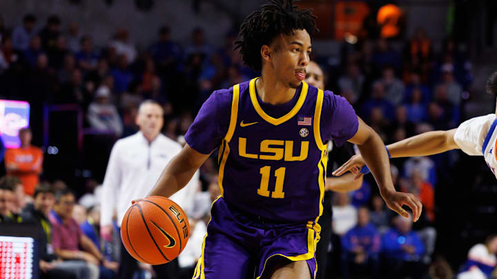 Jan 20, 2026; Gainesville, Florida, USA; Louisiana State Tigers guard Dedan Thomas Jr. (11) drives to the basket past Florida Gators guard Xaivian Lee (1) during the first half at Exactech Arena at the Stephen C. O'Connell Center. Mandatory Credit: Matt Pendleton-Imagn Images
