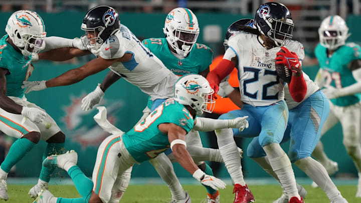 Tennessee Titans running back Derrick Henry (22) gets stopped in the backfield by Miami Dolphins safety Brandon Jones (29) during the second half of an NFL game at Hard Rock Stadium in Miami Gardens, Dec. 11, 2023.