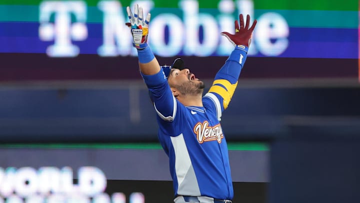 Mar 17, 2026; Miami, FL, United States; Venezuela third baseman Eugenio Suarez (7) reacts after hitting a RBI double against the United States in the ninth inning during the 2026 World Baseball Classic Championship game at loanDepot Park. Mandatory Credit: Sam Navarro-Imagn Images