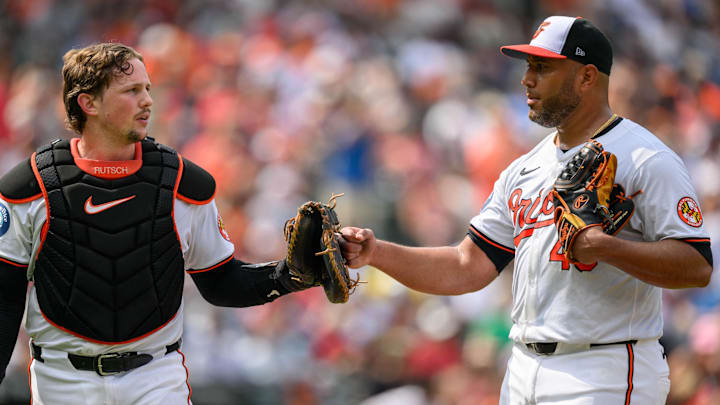 Aug 18, 2024; Baltimore, Maryland, USA; Baltimore Orioles pitcher Albert Suarez (49) and catcher Adley Rutschman (35) reacts during the sixth inning against the Boston Red Sox at Oriole Park at Camden Yards.
