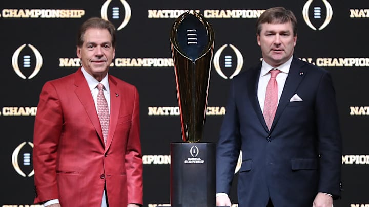 Former Alabama Crimson Tide coach Nick Saban and Georgia Bulldogs coach Kirby Smart with the College Football Playoff trophy