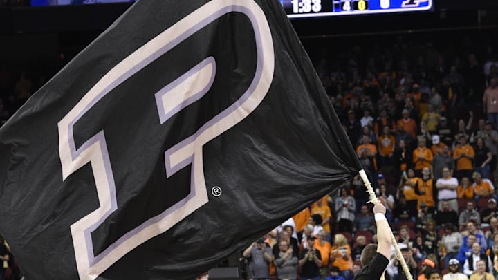 Purdue Boilermakers cheerleader flies a flag before the game 
