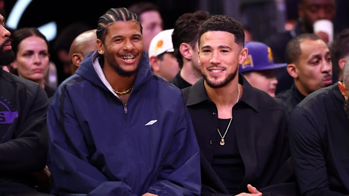 Feb 1, 2026; Phoenix, Arizona, USA; Phoenix Suns injured guards Jalen Green (left) and Devin Booker against the Los Angeles Clippers in the first half at Mortgage Matchup Center. Mandatory Credit: Mark J. Rebilas-Imagn Images
