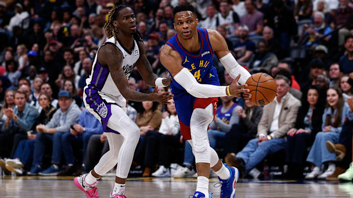 Mar 5, 2025; Denver, Colorado, USA; Denver Nuggets guard Russell Westbrook (4) controls the ball as Sacramento Kings guard Keon Ellis (23) guards in the fourth quarter at Ball Arena. Mandatory Credit: Isaiah J. Downing-Imagn Images