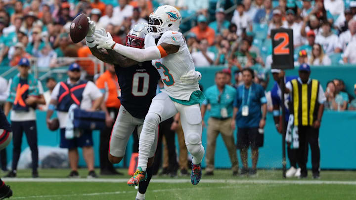 New England Patriots cornerback Christian Gonzalez (0) breaks up a pass to Miami Dolphins wide receiver Odell Beckham Jr. (3) during the first half at Hard Rock Stadium.
