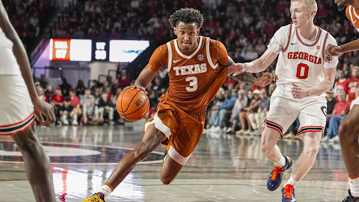 Texas Longhorns forward Dailyn Swain dribbles against Georgia Bulldogs guard Blue Cain (0) at Stegeman Coliseum. 