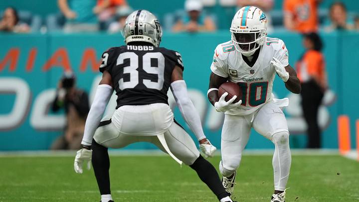Nov 19, 2023; Miami Gardens, Florida, USA; Miami Dolphins wide receiver Tyreek Hill (10) runs with the ball against Las Vegas Raiders cornerback Nate Hobbs (39) during the second half at Hard Rock Stadium. Mandatory Credit: Jasen Vinlove-USA TODAY Sports Nov 19, 2023; Miami Gardens, Florida, USA; Miami Dolphins wide receiver Tyreek Hill (10) runs with the ball against Las Vegas Raiders cornerback Nate Hobbs (39) during the second half at Hard Rock Stadium. Mandatory Credit: Jasen Vinlove-USA TODAY Sports