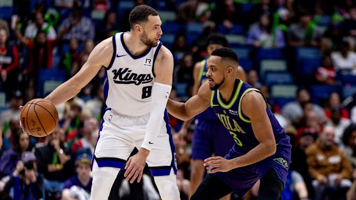 Feb 12, 2025; New Orleans, Louisiana, USA;  Sacramento Kings guard Zach LaVine (8) dribbles against New Orleans Pelicans guard CJ McCollum (3) during the second half at Smoothie King Center. Mandatory Credit: Stephen Lew-Imagn Images