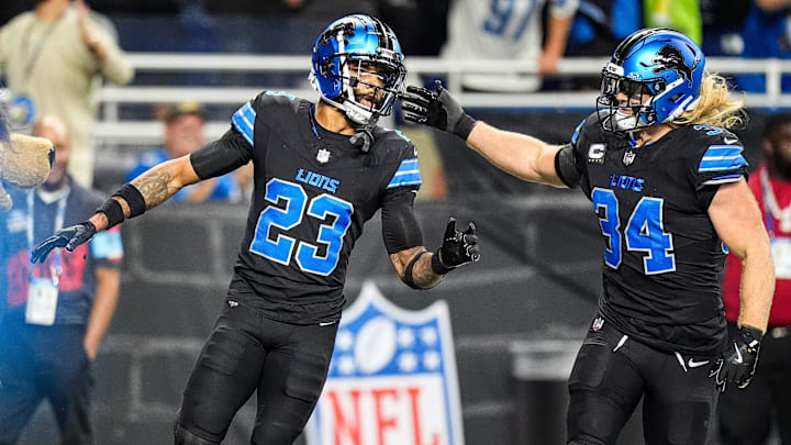Detroit Lions cornerback Carlton Davis III (23) celebrates a fumble recovery with linebacker Alex Anzalone against Seattle Seahawks during the first half at Ford Field in Detroit on Monday, Sept. 30, 2024.